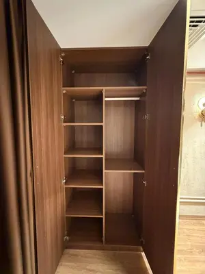 a closet with wooden doors and shelves at city istiklal in Istanbul