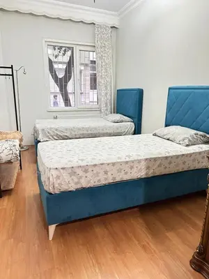 two beds in a room with a window at Twin Double X2 Room in Istanbul
