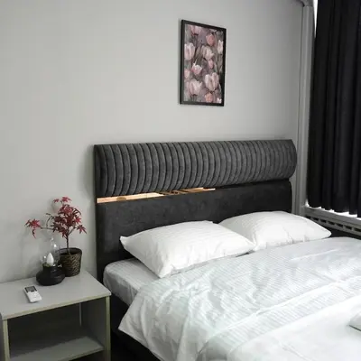 a bedroom with two beds and a black headboard at Accommodation Near the Bull Statue in Kadikoy in Istanbul