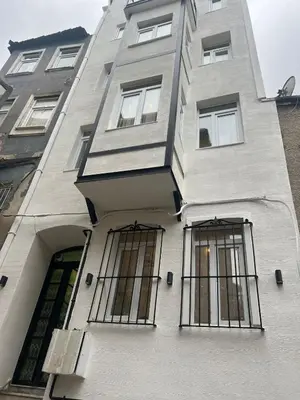 a building with barred windows on the side of it at taksimrosboutique in Istanbul