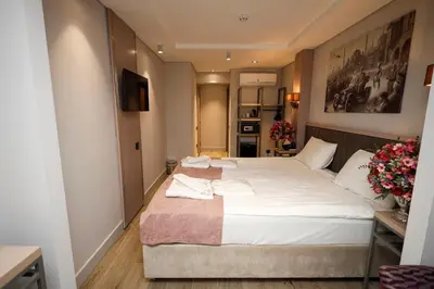 a bedroom with a large bed with white sheets at The Diamond City Hotel Yenikapı in Istanbul