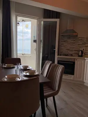 a kitchen with a table and chairs and a dining room at Breathtaking view apartment in Istanbul