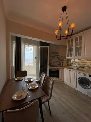 a kitchen with a table and chairs and a dining room at Breathtaking view apartment in Istanbul