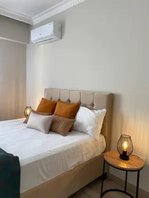 a bedroom with a large bed with pillows and a table at Breathtaking view apartment in Istanbul