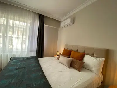 a bedroom with a large bed with a window at Breathtaking view apartment in Istanbul