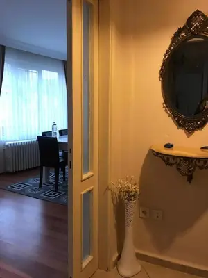 a room with a mirror and a dining room with a table at Apartment on Pier Loti street with a nice view in Istanbul
