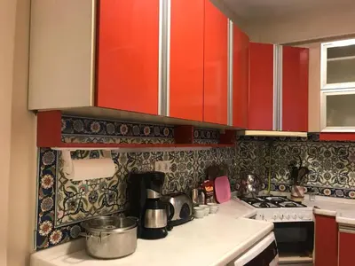 a kitchen with red cabinets and a counter top at Apartment on Pier Loti street with a nice view in Istanbul