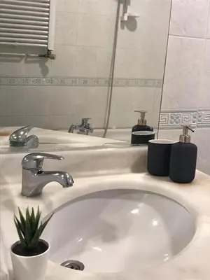 a bathroom sink with a faucet and a mirror at Apartment on Pier Loti street with a nice view in Istanbul