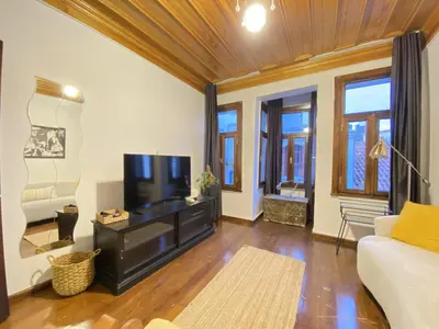 a living room with a couch and a flat screen tv at Historic Lütfi Pasha House in Balat 2BR in Istanbul