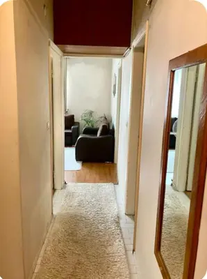 a hallway with a living room with a couch and a mirror at Romantic Private Room, Beşiktaş-İstanbul in Istanbul
