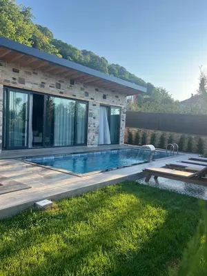 a swimming pool in the backyard of a house at Rubyy Resort Luxury Stone Villa with Private Pool in Kartepe