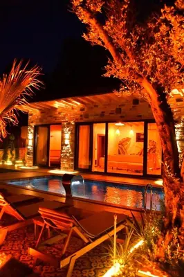 a house with a swimming pool at night at Rubyy Resort Luxury Stone Villa with Private Pool in Kartepe