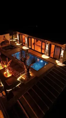 an overhead view of a swimming pool at night at Rubyy Resort Luxury Stone Villa with Private Pool in Kartepe