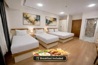 a hotel room with two beds and a tray of food at VALENCE SUITES Taksim in Istanbul