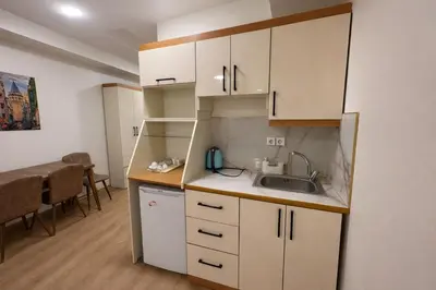 a small kitchen with white cabinets and a sink at VALENCE SUITES Taksim in Istanbul