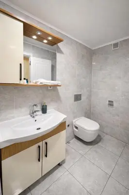 a bathroom with a white sink and a toilet at VALENCE SUITES Taksim in Istanbul