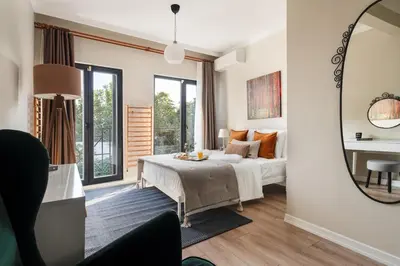 a bedroom with a bed and a mirror at Iconic Sea View Duplex w Terrace in Balat in Istanbul