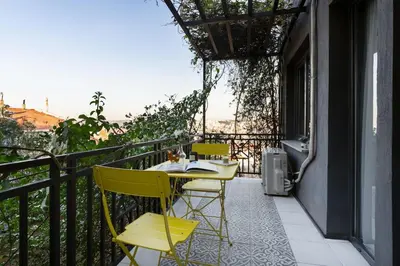 a balcony with a table and chairs on a balcony at Iconic Sea View Duplex w Terrace in Balat in Istanbul