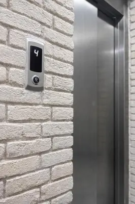 a lightswitch on a brick wall next to a elevator at Signature Suites in Taksim in Istanbul