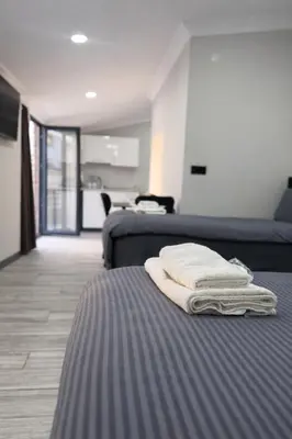 two beds in a room with towels on the bed at Signature Suites in Taksim in Istanbul