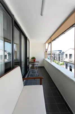 a balcony with white furniture and large windows at Happy Homes & Apartments Taksim in Istanbul