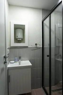 a bathroom with a sink and a shower at Happy Homes & Apartments Taksim in Istanbul