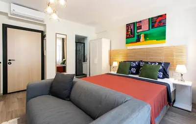 a bedroom with a bed and a couch at Happy Homes & Apartments Taksim in Istanbul