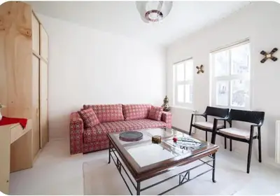 a living room with a pink couch and a table at Two seperate apartments for friends and families in Istanbul