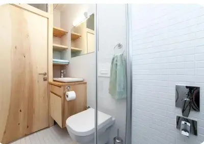 a bathroom with a toilet and a glass shower at Two seperate apartments for friends and families in Istanbul