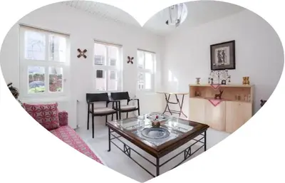 a living room with a table in the middle of a heart at Two seperate apartments for friends and families in Istanbul
