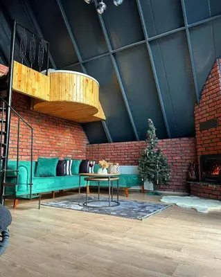 a living room with a green couch and a brick wall at Sakaryabungalow in Geyve