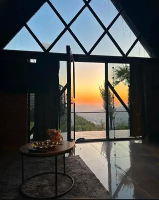 a room with a table in front of a large window at Sakaryabungalow in Geyve