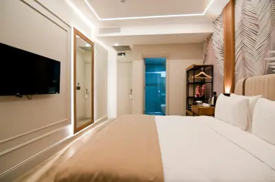 a bedroom with a large bed and a flat screen tv at Forty Nişantaşı Hotel & SPA in Istanbul