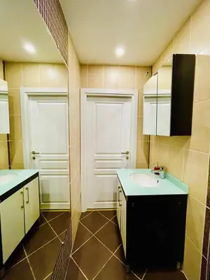 a bathroom with a sink and two doors at ekinci cihangir in Istanbul