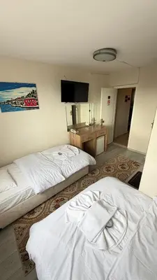 a hotel room with two beds and a television at otel efendi in Istanbul
