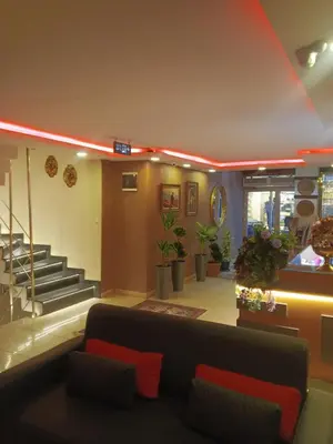 a living room with a couch and a staircase at otel efendi in Istanbul