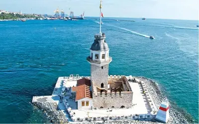 a lighthouse in the middle of a body of water at otel efendi in Istanbul