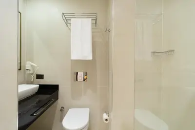 a bathroom with a toilet and a glass shower at Atik Hotel Nişantaşı in Istanbul