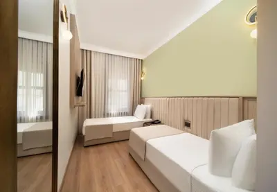 a hotel room with two beds and a bathroom at Atik Hotel Nişantaşı in Istanbul