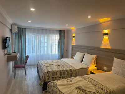 a hotel room with two beds and a television at Fly Apartment Hotel in Istanbul