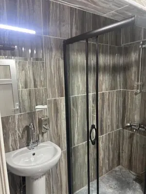 a bathroom with a sink and a shower at Fly Apartment Hotel in Istanbul