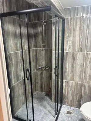 a shower with a glass door in a bathroom at Fly Apartment Hotel in Istanbul