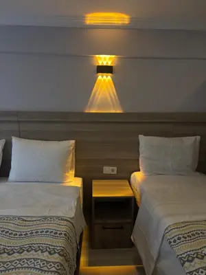 a hotel room with two beds and a light at Fly Apartment Hotel in Istanbul