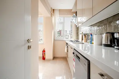 a kitchen with white counter tops and a sink at Samuray in Istanbul