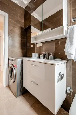 a kitchen with a sink and a washing machine at Samuray in Istanbul