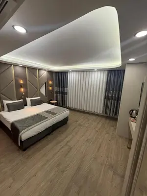 a bedroom with a large bed and wooden floors at Elysia Plus in Istanbul