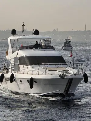 a white boat in the water with two other boats at Rotavira YAT KİRALAMA PLATFORMU in Istanbul