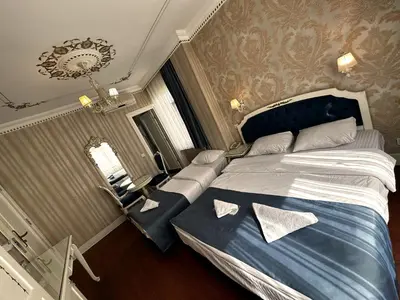 a bedroom with a large bed with two pillows on it at Alyon Hotell in Istanbul