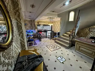 a living room with a staircase and a mirror at Alyon Hotell in Istanbul