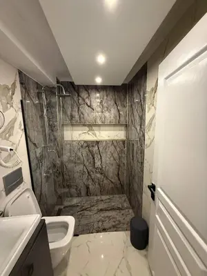 a bathroom with a shower and a toilet and a sink at Cozy 1BR Basement Apartment Close to Metro in Istanbul